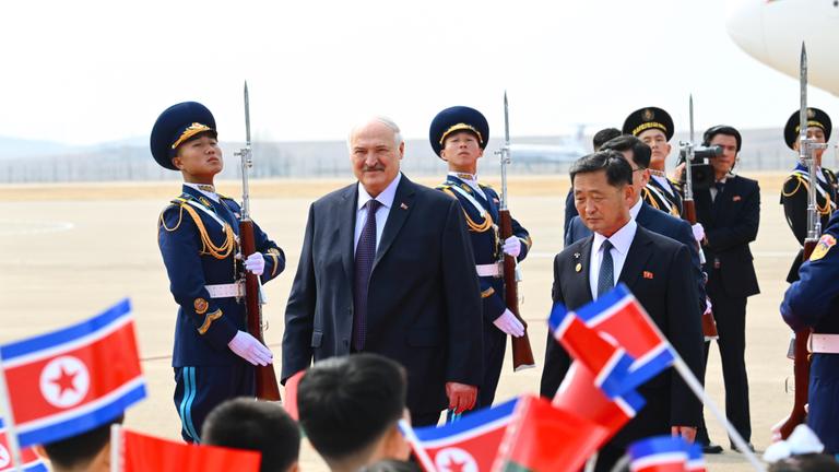 Der Erste Stellvertretende Ministerpräsident Nordkoreas, Kim Tok-hun, und der belarussische Präsident Alexander Lukaschenko (von rechts nach links, Mitte) bei einer Begrüßungszeremonie am internationalen Flughafen Sunan anlässlich Lukaschenkos Ankunft.