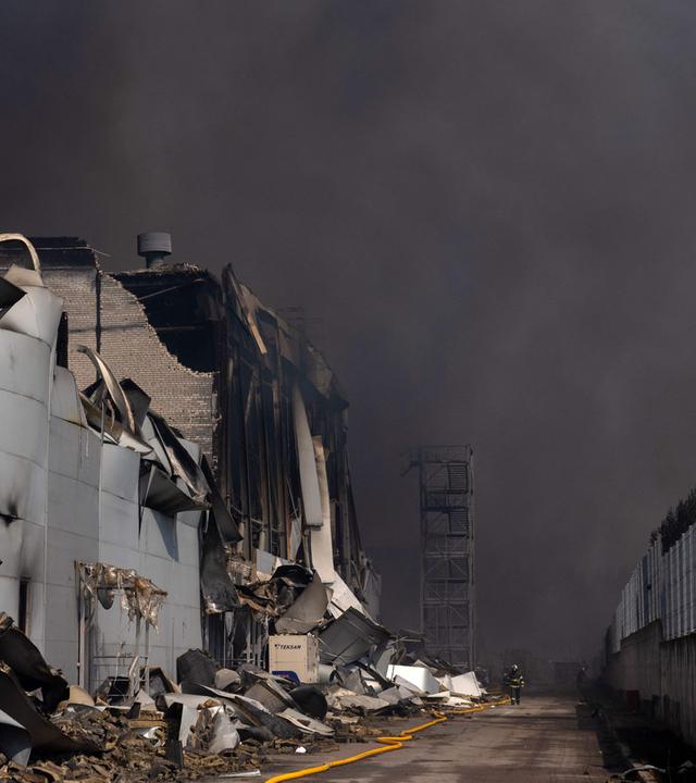 Ein ukrainischer Feuerwehrmann ist dabei, einen Brand zu löschen, der nach massiven russischen Raketen- und Drohnenangriffen in Kiew am 5. August 2026 im Zuge der russischen Invasion in der Ukraine ausgebrochen ist. 