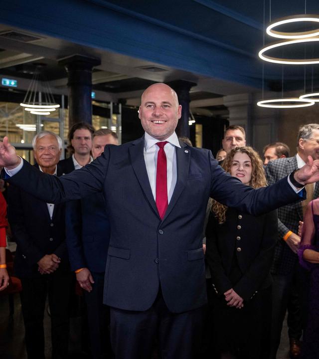 Lettlands Premierminister Andris Kulbergs reagiert freudig und hebt beide Arme in die Höhe, während er am Wahlabend seiner Partei "Apvienotais Saraksts" (Vereinigte Liste) am 3. Oktober 2026 in Riga auf die ersten Ergebnisse der Nachwahlbefragungen zu den Parlamentswahlen wartet.