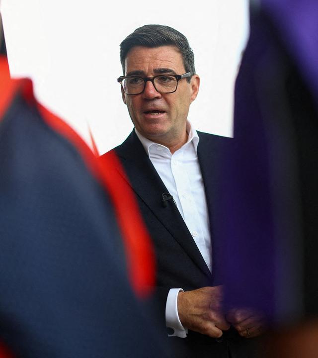 Der britische Premierminister Andy Burnham spricht mit Mitarbeitern während seines Besuchs am Busbahnhof von Wolverhampton