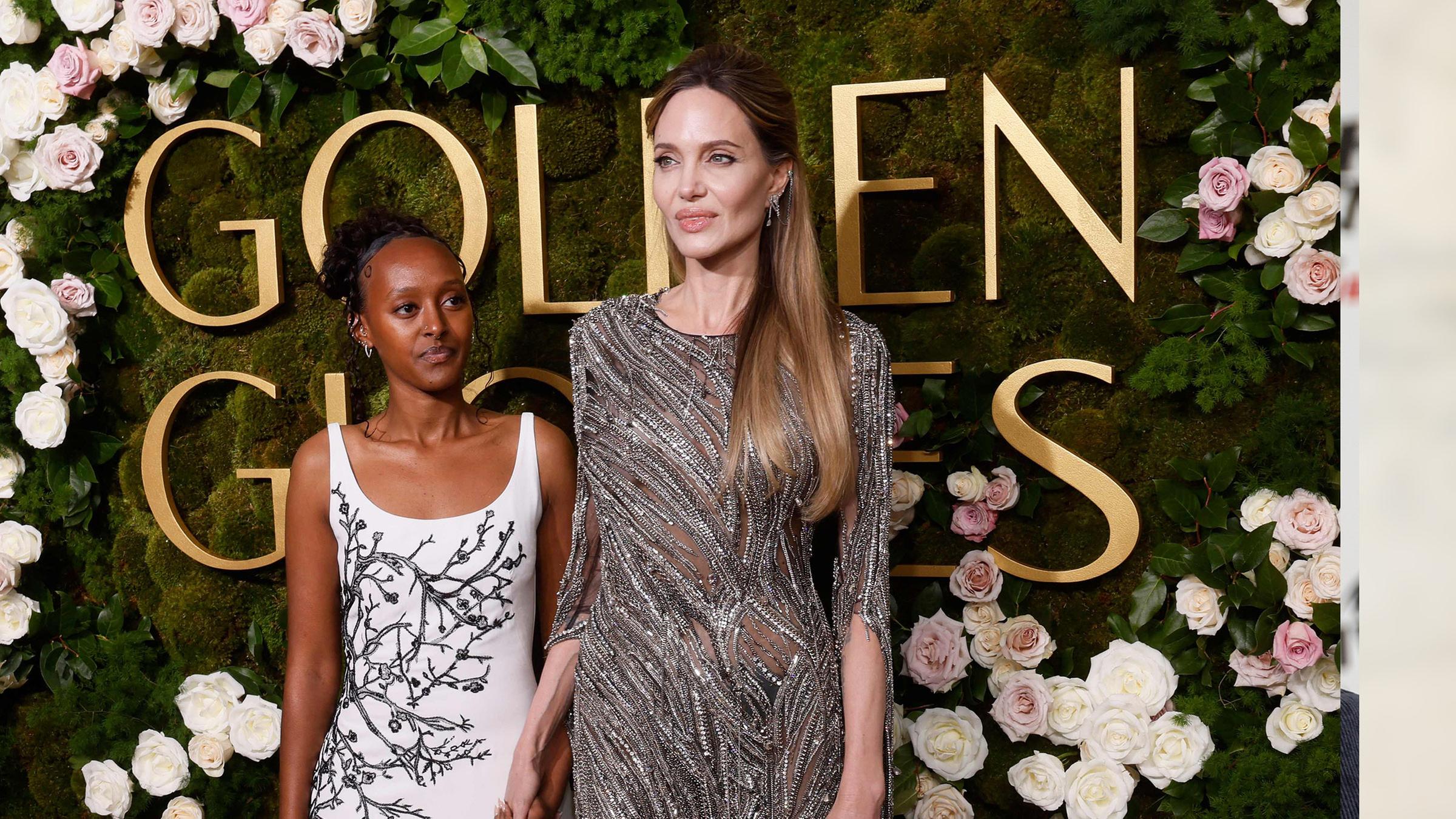 Die Ehe von Brad Pitt und Angelina Jolie ist seit Anfang Januar geschieden. Eine Tatsache, die die Schauspielerin mit Tochter Zahara bei den Golden Globes einfach weglächelte. (06.01.2025)