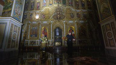 Ein Priester trägt während eines russischen Angriffs auf Kiew Kirchengeräte aus der brennenden Mariä-Entschlafens-Kathedrale der Kiewer Höhlenkloster am 15.06.2026.
