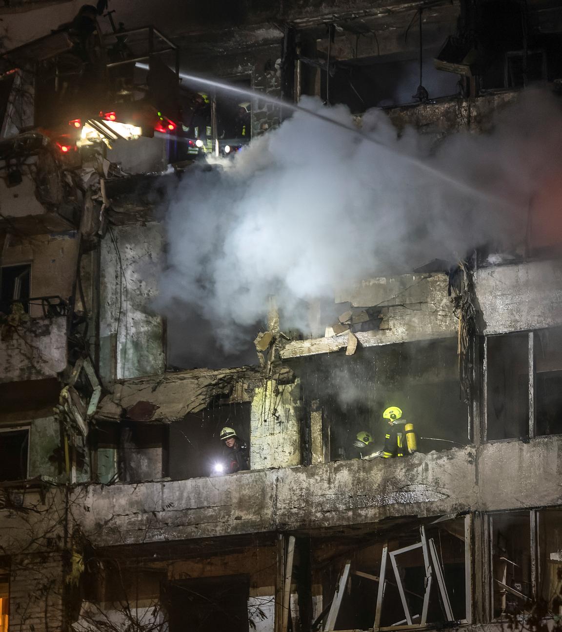 Ukrainian rescuers work at the site of a Russian strike on a nine-storey residential building in Kyiv