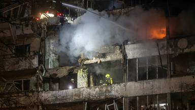 Ukrainian rescuers work at the site of a Russian strike on a nine-storey residential building in Kyiv