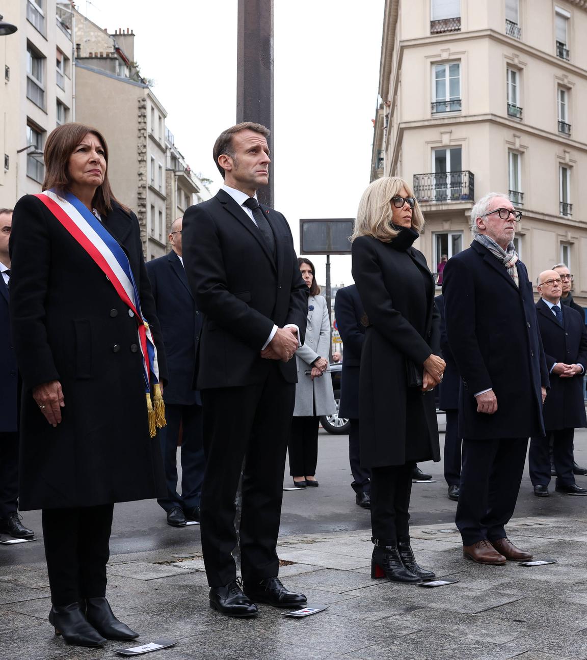 Paris mayor Anne Hidalgo, President of France Emmanuel Macron, French President's wife Brigitte Macron pay tribute to victims at the intersection of of Bichat and Alibert streets near "Le Petit Cambodge" and "Le Carillon" 