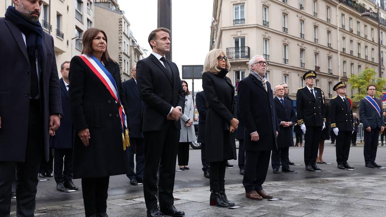 Paris mayor Anne Hidalgo, President of France Emmanuel Macron, French President's wife Brigitte Macron pay tribute to victims at the intersection of of Bichat and Alibert streets near "Le Petit Cambodge" and "Le Carillon" 