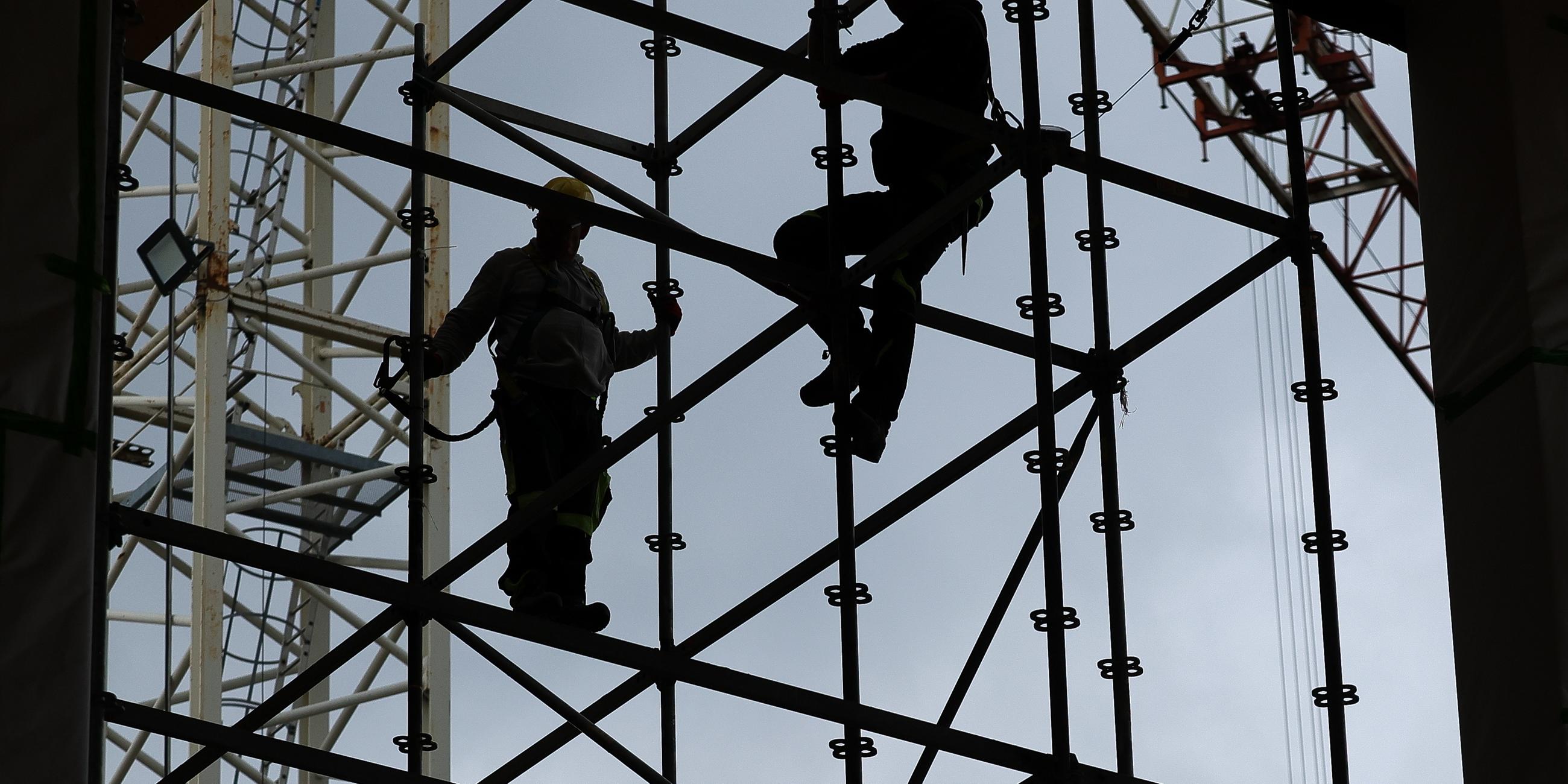 Symbolbild: Silhouetten von Bauarbeiten auf einer Baustelle