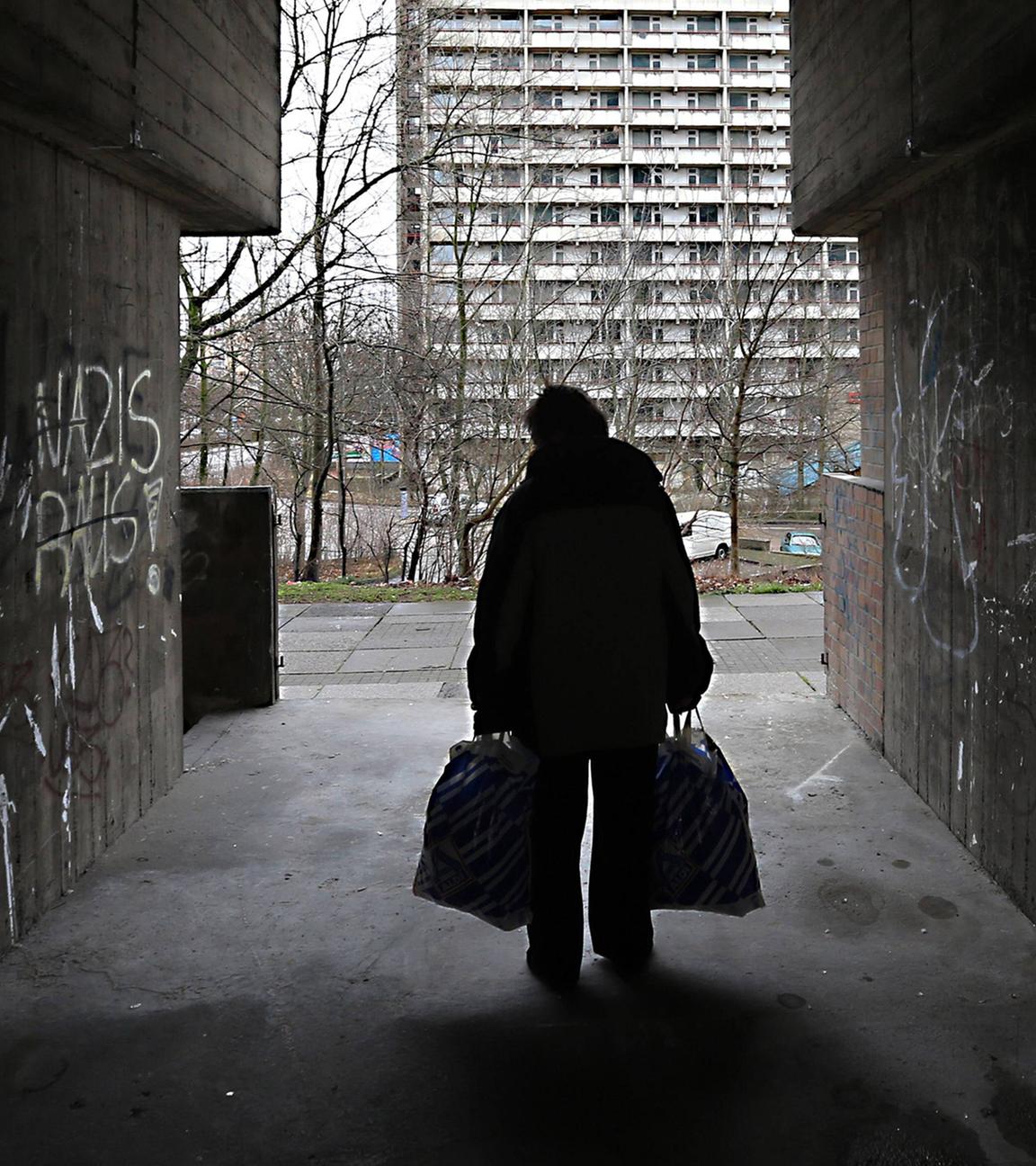 Archiv: Eine Frau in einer Unterfuehrung an einer Plattenbau-Siedlung in Halle-Neustadt am 21.02.2016