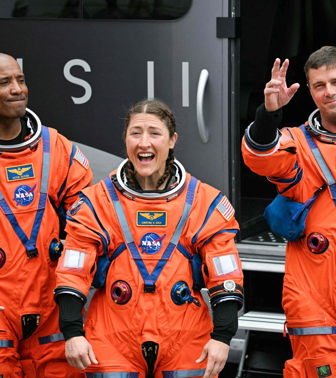 NASA astronauts Victor Glover, Artemis II pilot, Christina Koch, Artemis II mission specialist, and Reid Wiseman, Artemis II commander, walk out before boarding a bus to travel to the launch pad to board the Artemis II crewed lunar mission at Kennedy Space Center in Cape Canaveral, Florida, on April 1, 2026.