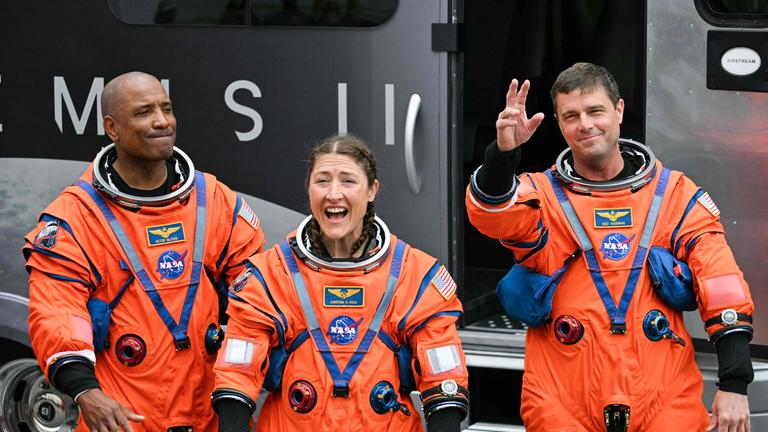 NASA astronauts Victor Glover, Artemis II pilot, Christina Koch, Artemis II mission specialist, and Reid Wiseman, Artemis II commander, walk out before boarding a bus to travel to the launch pad to board the Artemis II crewed lunar mission at Kennedy Space Center in Cape Canaveral, Florida, on April 1, 2026.
