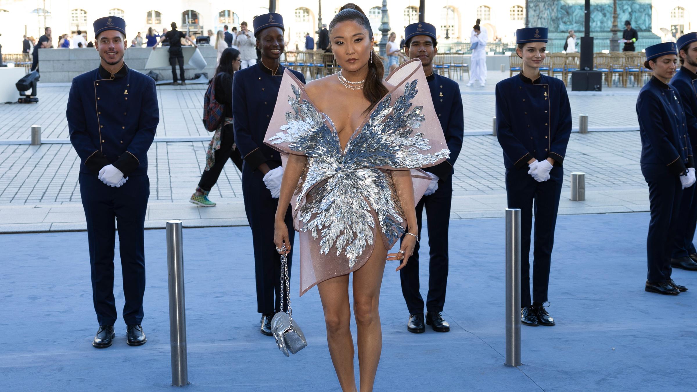 Ashley Park posiert auf blauem Teppich