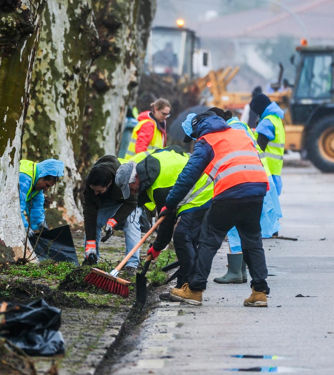 Volunteers clean up debris from streets after Storm Kristin passed through Embra in Marinha Grande
