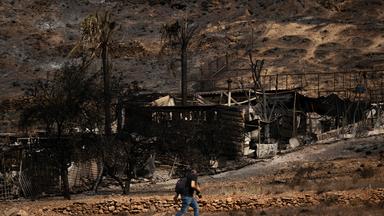 Ein Mann geht am 11.07.2026 in Bedar, bei Almería, an einem ausgebrannten Haus vorbei, nachdem ein Waldbrand mindestens 12 Menschen das Leben gekostet hatte. 