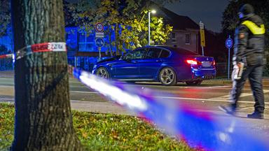 Ein BMW steht in der Nacht an einer Einsatzstelle in der Region Hannover. Einsatzkräfte haben zuvor auf ein Auto geschossen, dass zuvor in eine Gruppe von Menschen gefahren ist