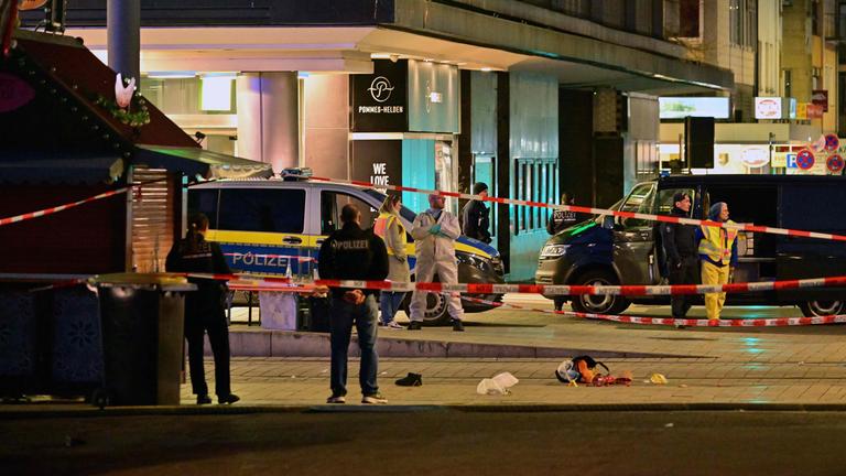 Police investigators work at the scene of car ramming attack in Mannheim, southwestern Germany on March 3, 2025.