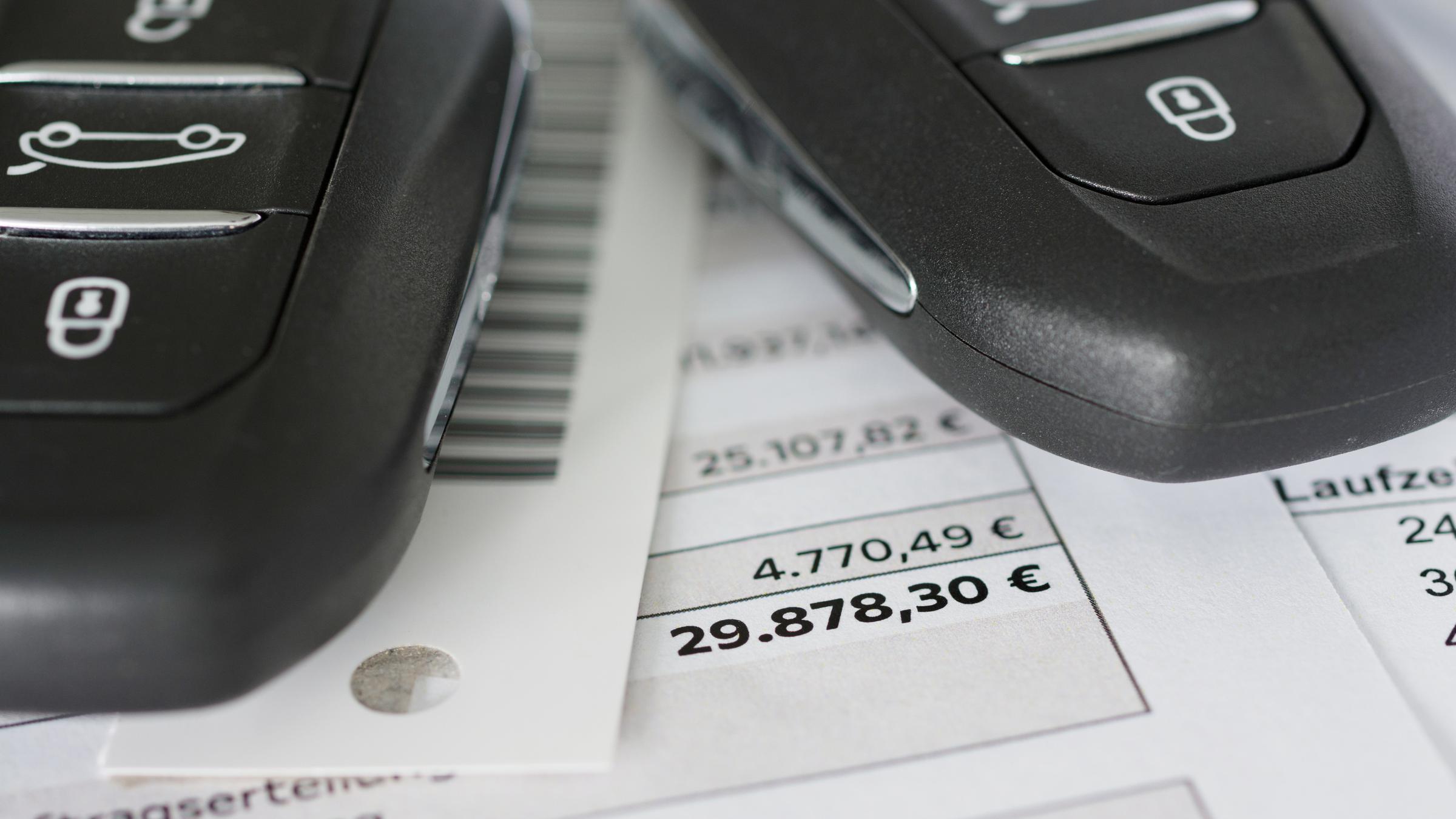 Autokaufvertrag mit Autoschlüssel in Nahaufnahme