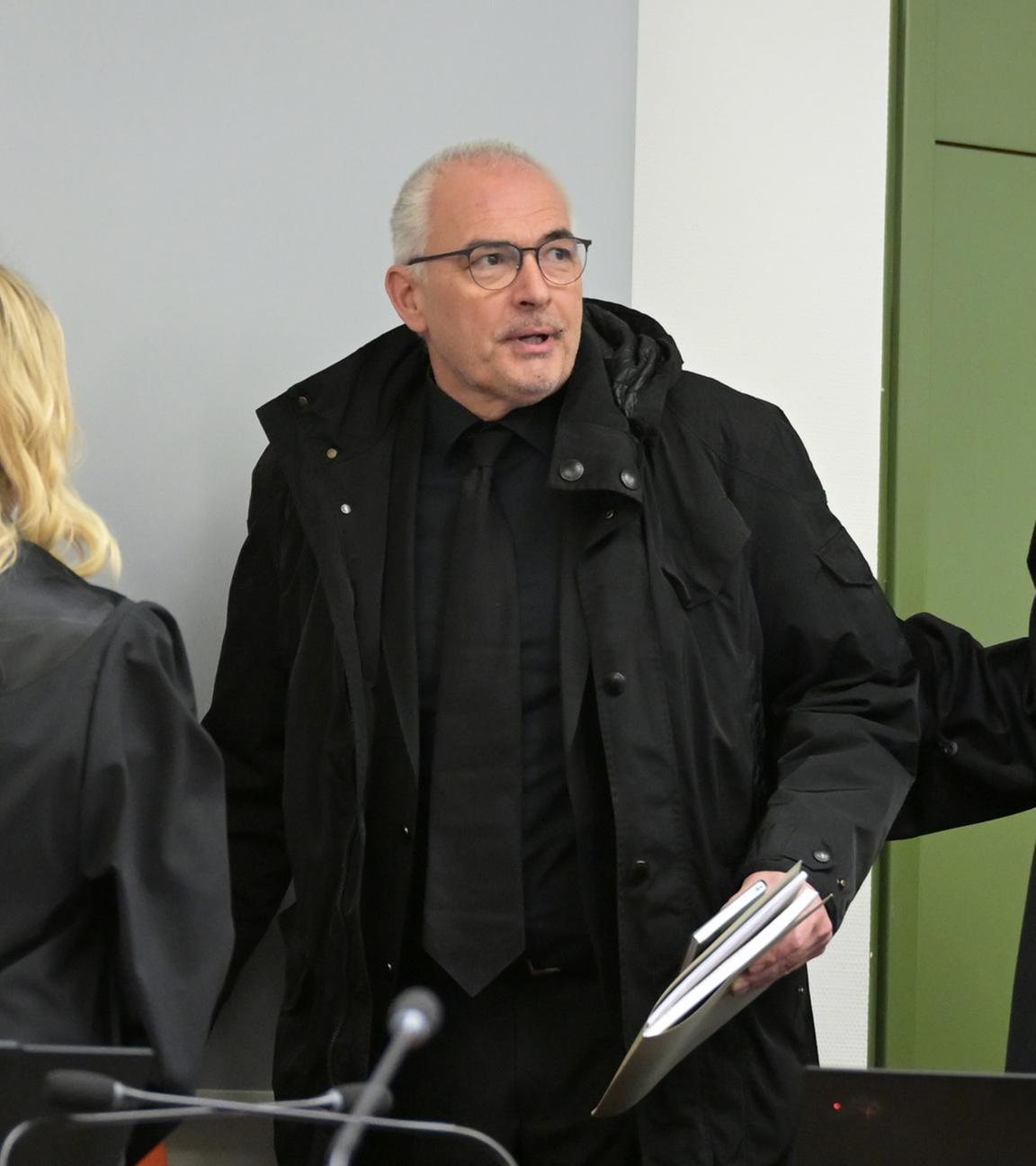 Der Ex-CDU-Abgeordnete Axel Fischer betritt vor Prozessbeginn wegen Bestechlichkeitsvorwürfen in der Aserbaidschan-Affäre den Gerichtssaal des OLG Karlsruhe, begleitet von seinen Anwälten.