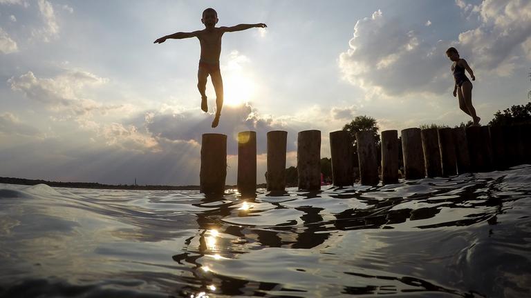 Ein Junge springt von einer Buhne in den Markkleeberger See