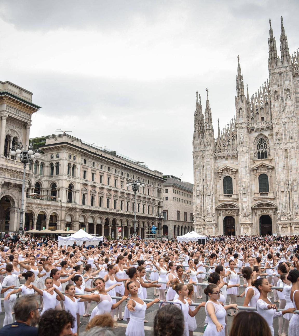 Italian ballet dancer Roberto Bolle (unseen) dances with 2000 students of dance schools at Piazza Duomo on the occasion of the OnDance dance festival (Ballo in Bianco), in Milan, Italy