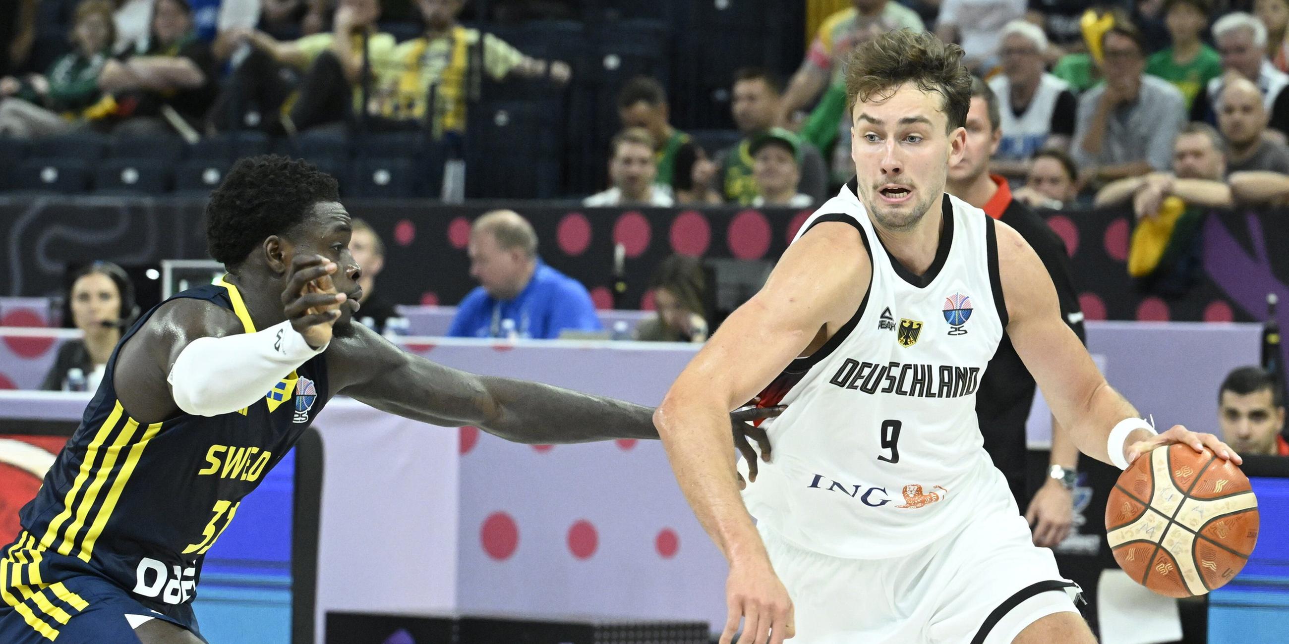 Sweden's Barra Njie (L) and Germany's Franz Wagner during the basketball FIBA EuroBasket 2025 group B match between Germany and Sweden in Tampere, Finland, on August 29, 2025.