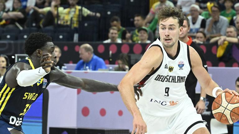 Sweden's Barra Njie (L) and Germany's Franz Wagner during the basketball FIBA EuroBasket 2025 group B match between Germany and Sweden in Tampere, Finland, on August 29, 2025.