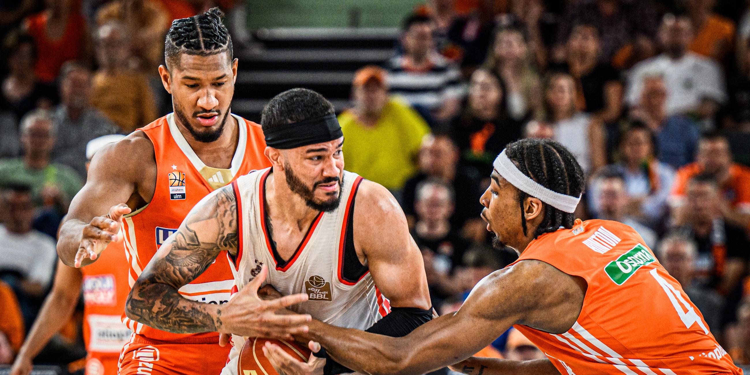 Nick Weiler-Babb vom FC Bayern versucht, den Ball gegen die Ulmer Karim Jallow (links) und Nate Hinton zu behaupten.