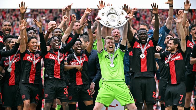 Leverkusens Lukas Hradecky hält die Meisterschale und jubelt mit seinen Mitspielern am 18.05.2024.