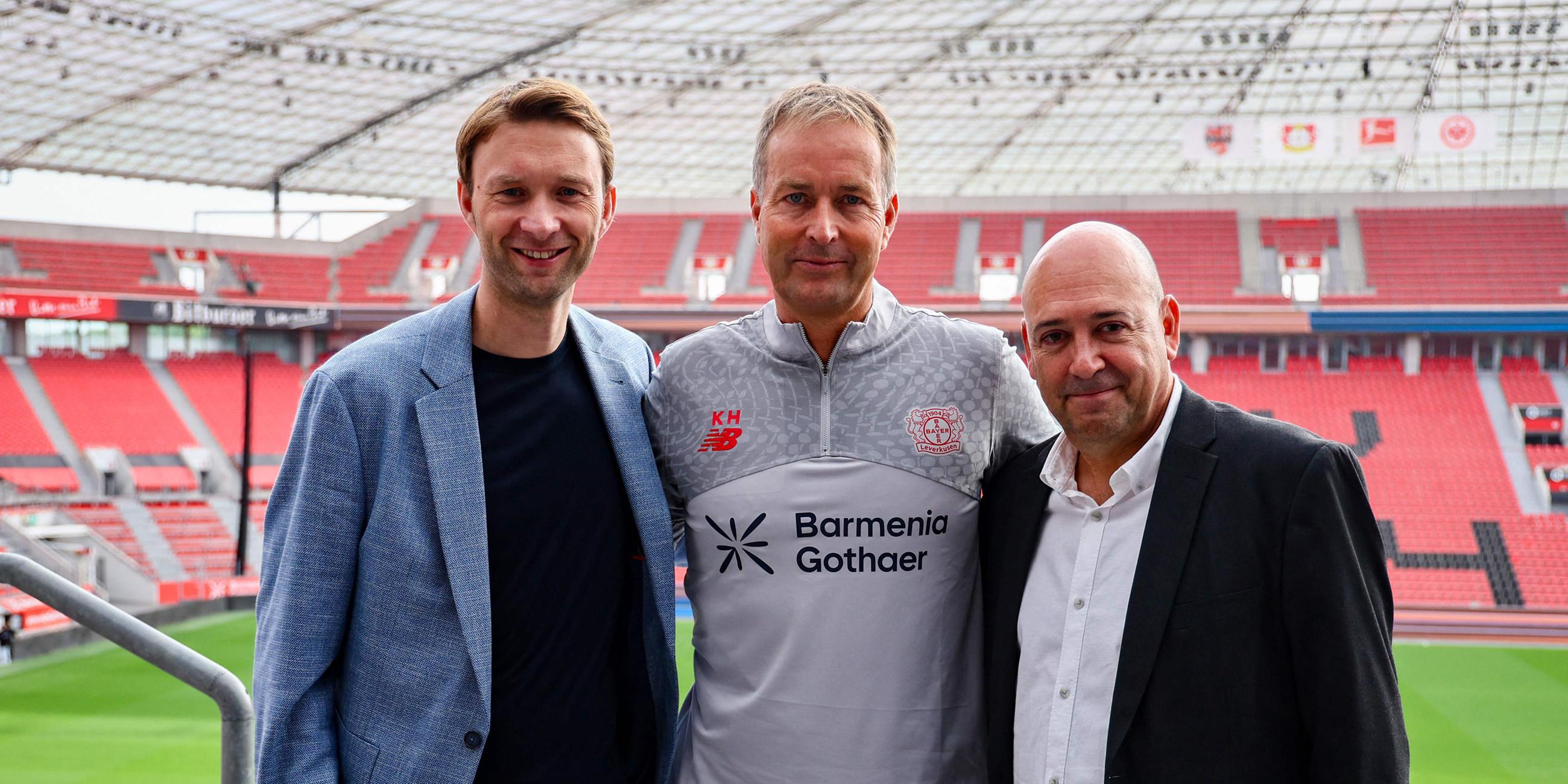 The new Danish head coach of German Bundesliga team Bayer Leverkusen, Kasper Hjulmand (C), CEO Fernando Carro De Prada (R) and Sporting Director Simon Rolfes (L) pose for a picture after a press conference at the BayArena in Leverkusen, western Germany, on September 10, 2025.