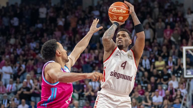 Joel Aminu (Telekom Baskets Bonn) versucht, einen Wurf von Xavier Rathan Mayes zu blocken