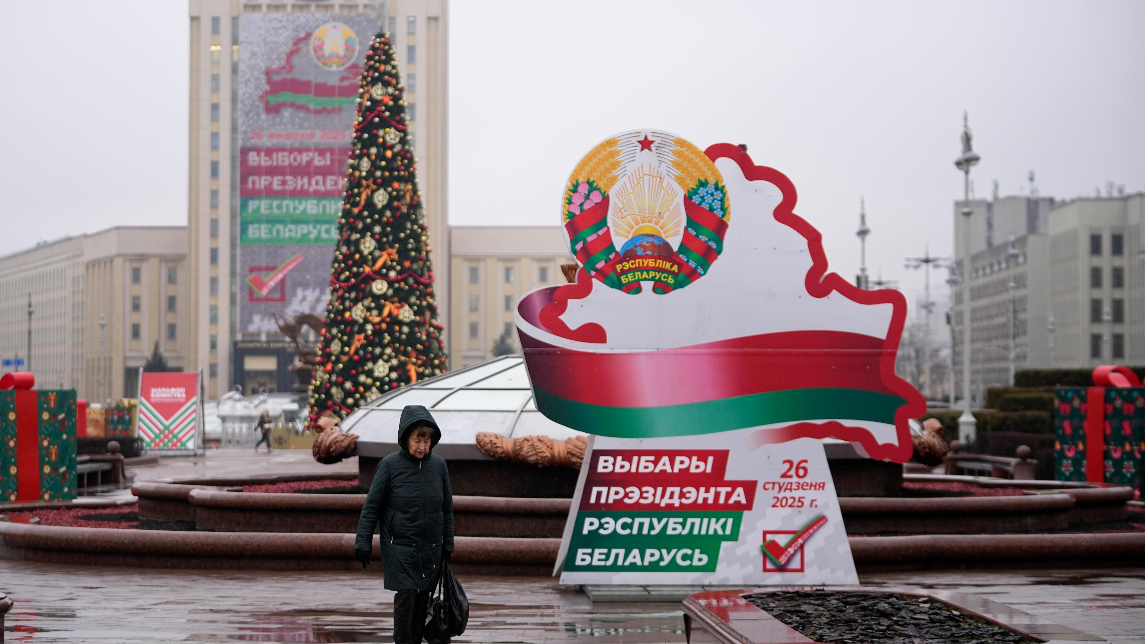 A woman walks past election billboards ahead of presidential elections in Minsk, Belarus, Friday, Jan. 24, 2025