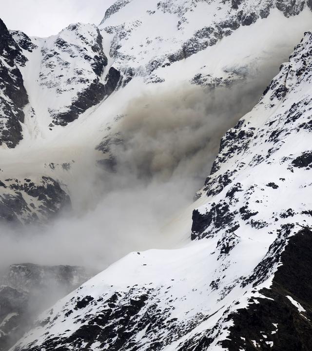 Dust from a rockfall rises on a flank of the Bietschhorn mountain in the Loetschental valley, taken from the village of Wiler,