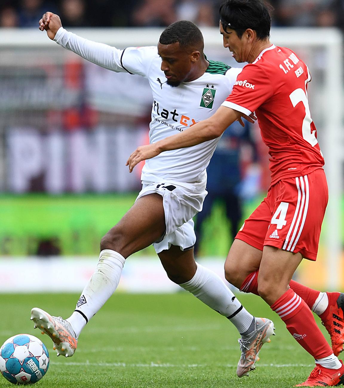 1. FC Union Berlin v Borussia Moenchengladbach - Stadion An der Alten Forsterei, Berlin, Germany - August 29, 2021 Borussia Moenchengladbach's Alassane Plea in action with 1. FC Union Berlin's Genki Haraguchi