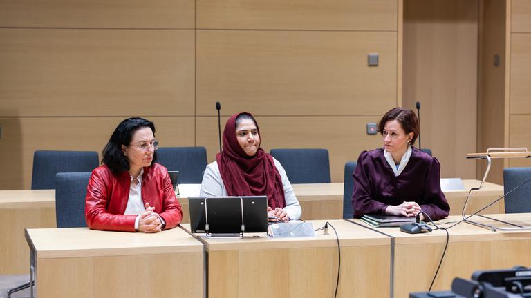 Klägerin Humaira Waseem (m) sitzt mit ihren Anwältinnen Fatma Bostan (l) und Ines Bodenstein (r) im Vorfeld einer Urteilsverkündung