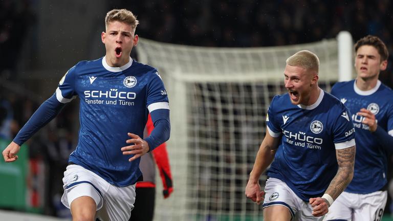 Bielefelds Torschütze Julian Kania (l) feiert seinen Treffer per Elfmeter zum 2:0 mit Louis Oppie (2.v.r) und Maximilian Grosser (r).