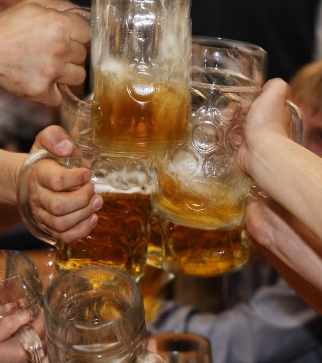 Oktoberfestbesucher stoßen mit Bier an