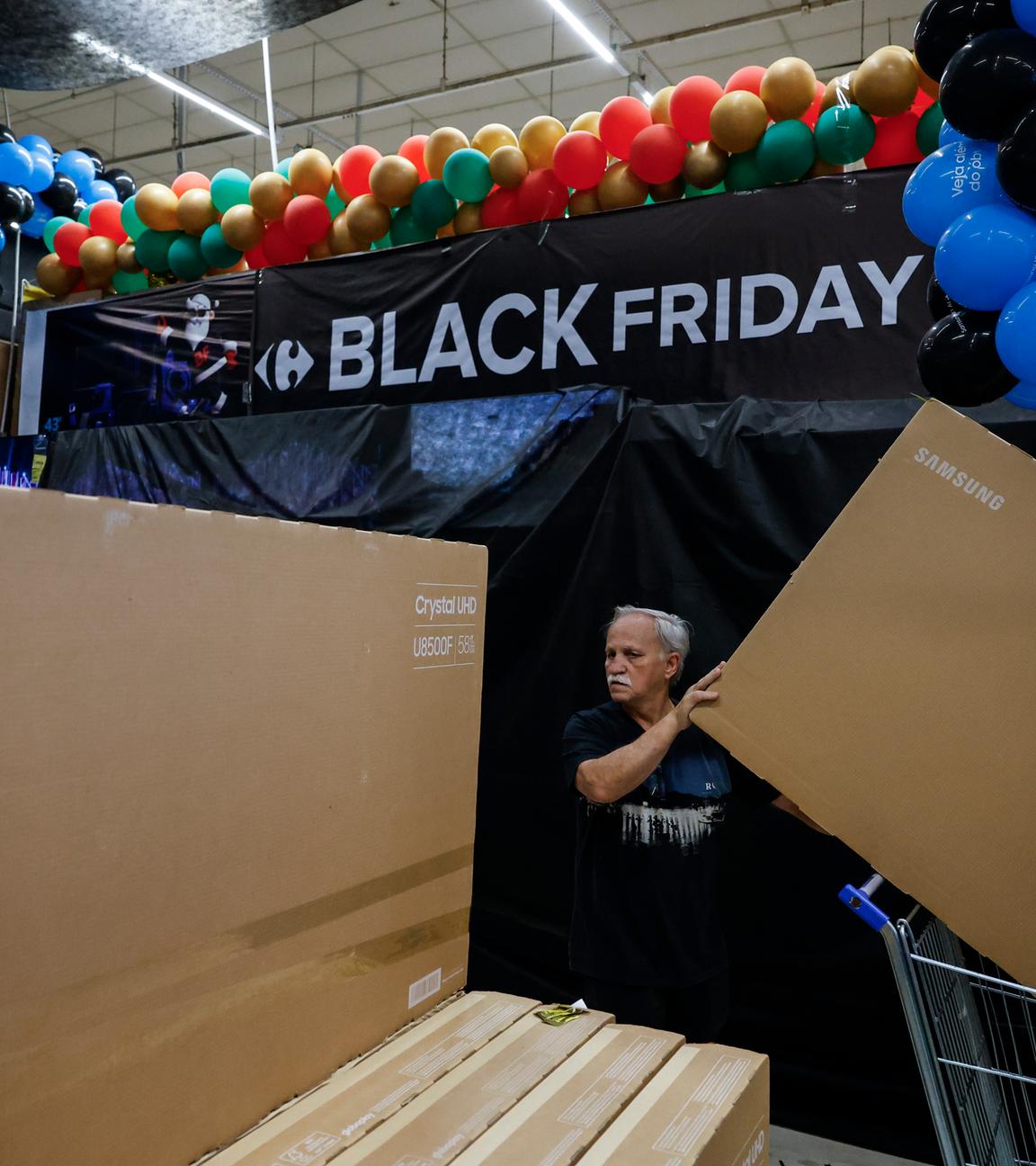 People buy televisions at a supermarket ahead of Black Friday in Sao Paulo, Brazil, 27 November 2025.