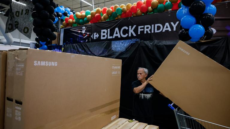 People buy televisions at a supermarket ahead of Black Friday in Sao Paulo, Brazil, 27 November 2025.