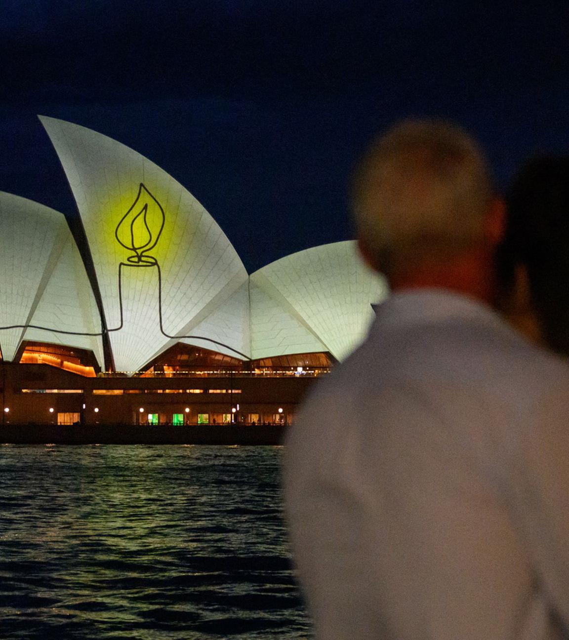  The Sydney Opera House is illuminated with candlelights in Sydney on December 21, 2025, as part of a national day of reflection honouring the victims of the Bondi Beach terrorist attack.