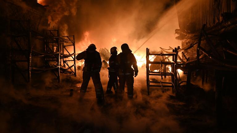 Ukrainische Feuerwehrleute löschen ein Feuer am Ort eines Drohnenangriffs auf Industrieanlagen in Charkiw am 04.05.2024