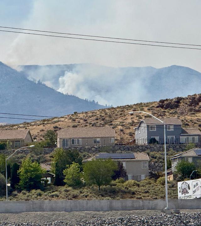 In der Ferne steigen Rauchwolken auf, während in Reno, Nevada, ein Waldbrand wütet.