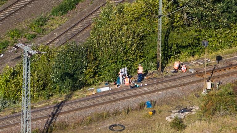 Niedersachsen, Lehrte: Mitarbeiter der Deutschen Bahn arbeiten nach einem Brand an einer Bahnstrecke in der Nähe eines Stellwerkes.