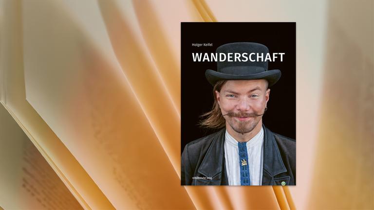 Auf dem Cover des Buches ist ein Mann mit Schnurrbart und Zimmermannstracht zu sehen.