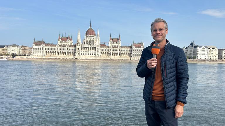 Moderator Andreas Klinner vor dem Parlamentsgebäude in Budapest