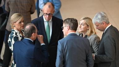Bundeskanzler Friedrich Merz (CDU, in der M, r) unterhält sich mit Kabinettsmitgliedern nach der namentlichen Abstimmung zum Tankrabatt bzw. dem Energiesteuergesetz.