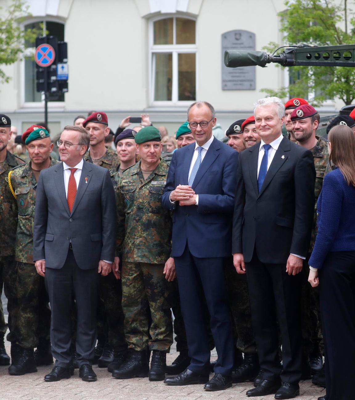 German Defence Minister Boris Pistorius, German Chancellor Friedrich Merz, Lithuanian President Gitanas Nauseda and Lithuanian Defence Minister Dovile Sakaliene pose for a group photograph with German servicemen and servicewomen after the inauguration of the German 45th Armoured Brigade 'Lithuania', at the Cathedral Square in Vilnius