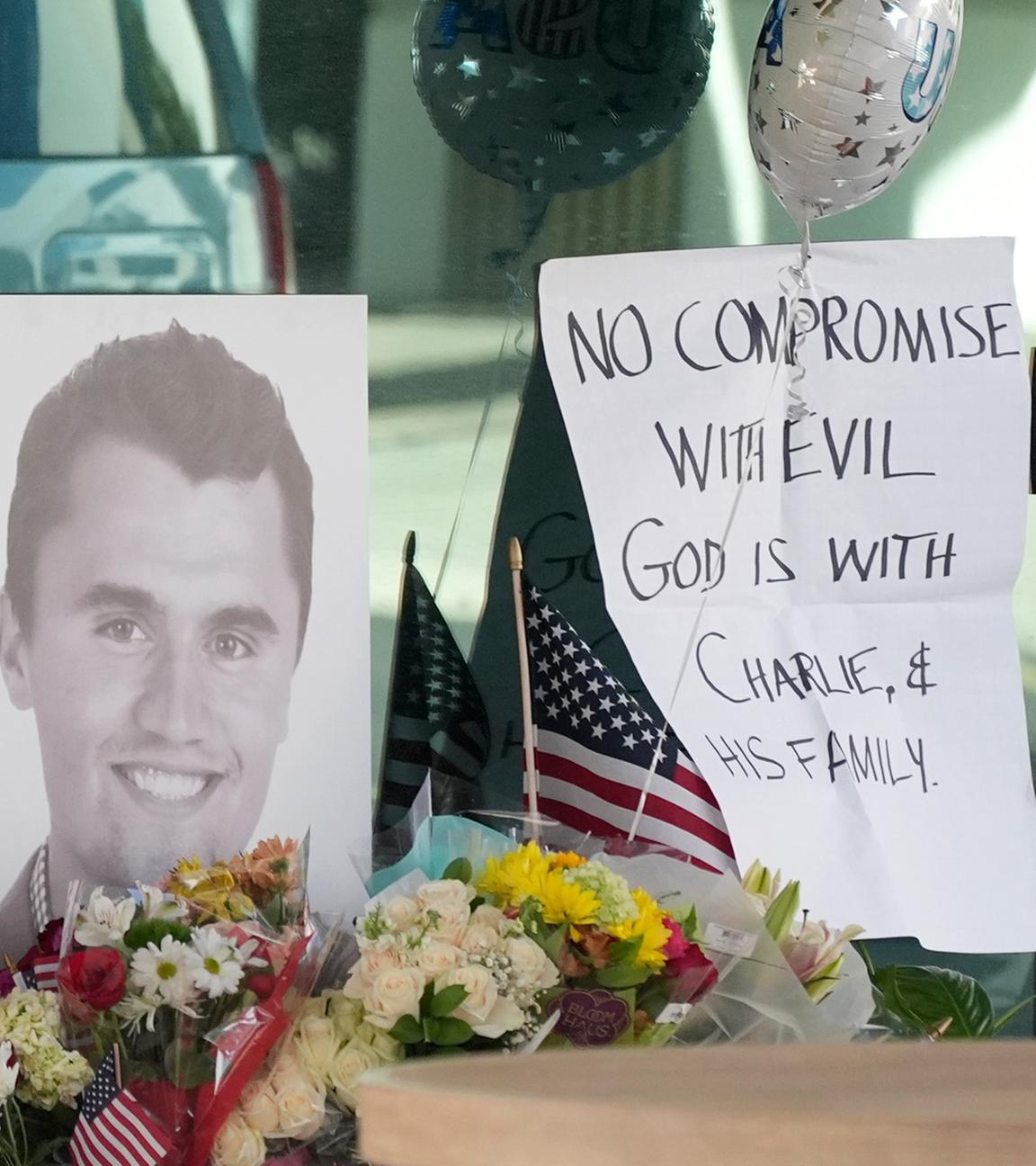 Well-wishers pay their respects at a makeshift memorial at the national headquarters of Turning Point USA shown after the shooting death of Charlie Kirk, the co-founder and CEO of the organization, during a Utah college event Wednesday, Sept. 10, 2025, in Phoenix