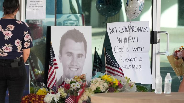 Well-wishers pay their respects at a makeshift memorial at the national headquarters of Turning Point USA shown after the shooting death of Charlie Kirk, the co-founder and CEO of the organization, during a Utah college event Wednesday, Sept. 10, 2025, in Phoenix