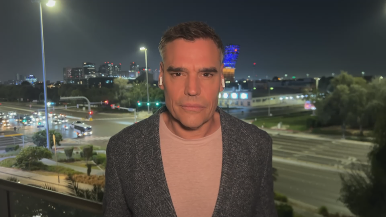 ZDF-Korrespondent Armin Coerper aus Abu Dhabi vor befahrener Kreuzung bei Dunkelheit