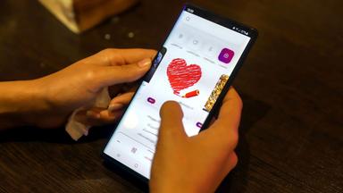 Frau schaut auf eine Dating-App