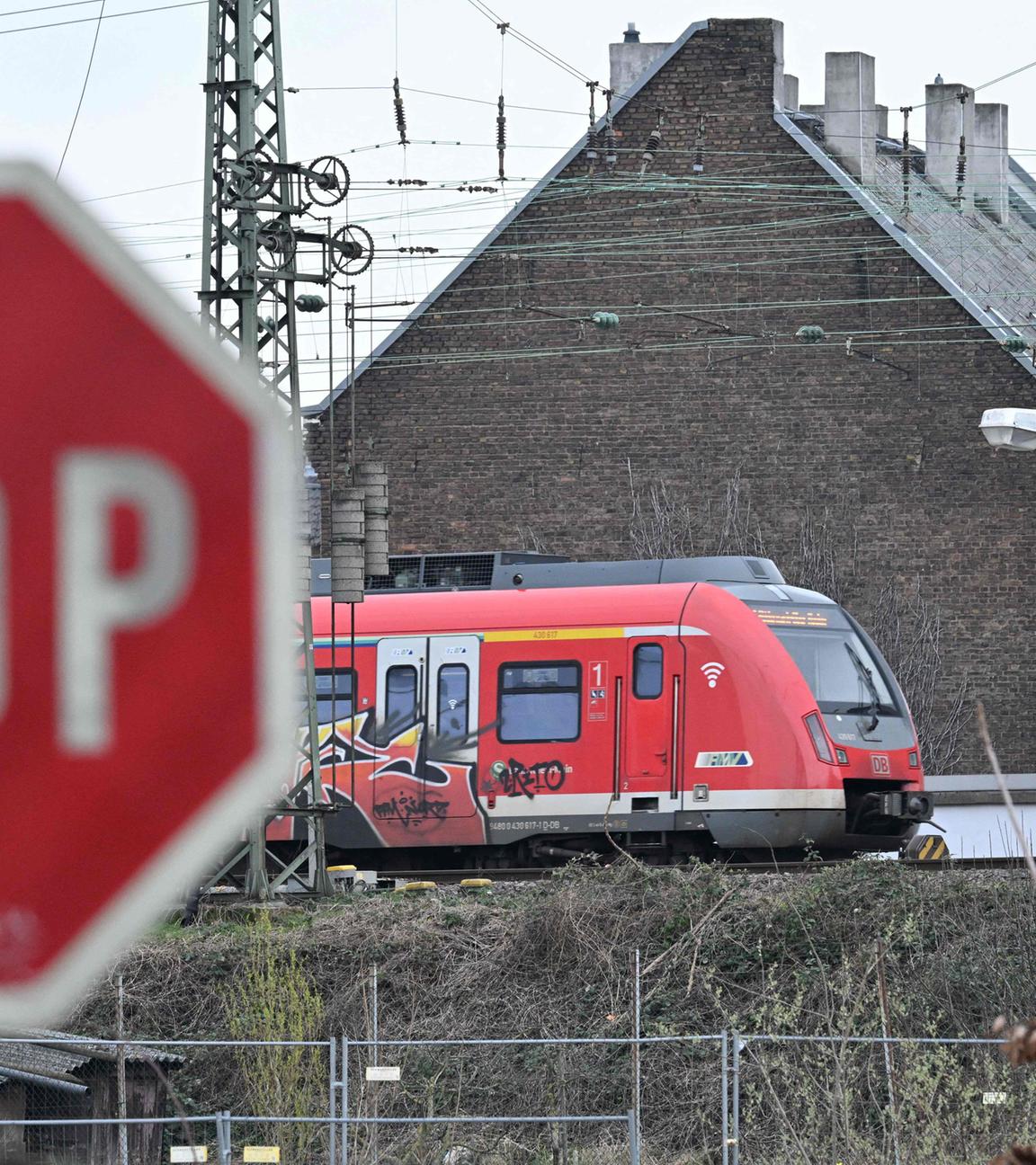 Stoppschild vor einer Regionalbahn der DB